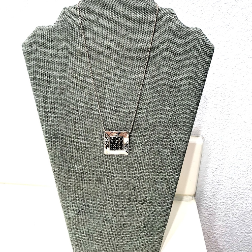 Silver pendant and necklace, designer signature at the back.